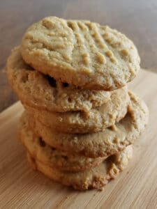 sourdough peanut butter cookies stacked on wooden board