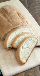 sliced Italian loaf on wooden cutting board