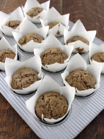 sourodugh cinnamon muffins in muffin tin on wooden table