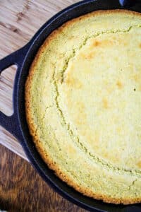 sourdough cornbread in cast iron skillet on wooden table