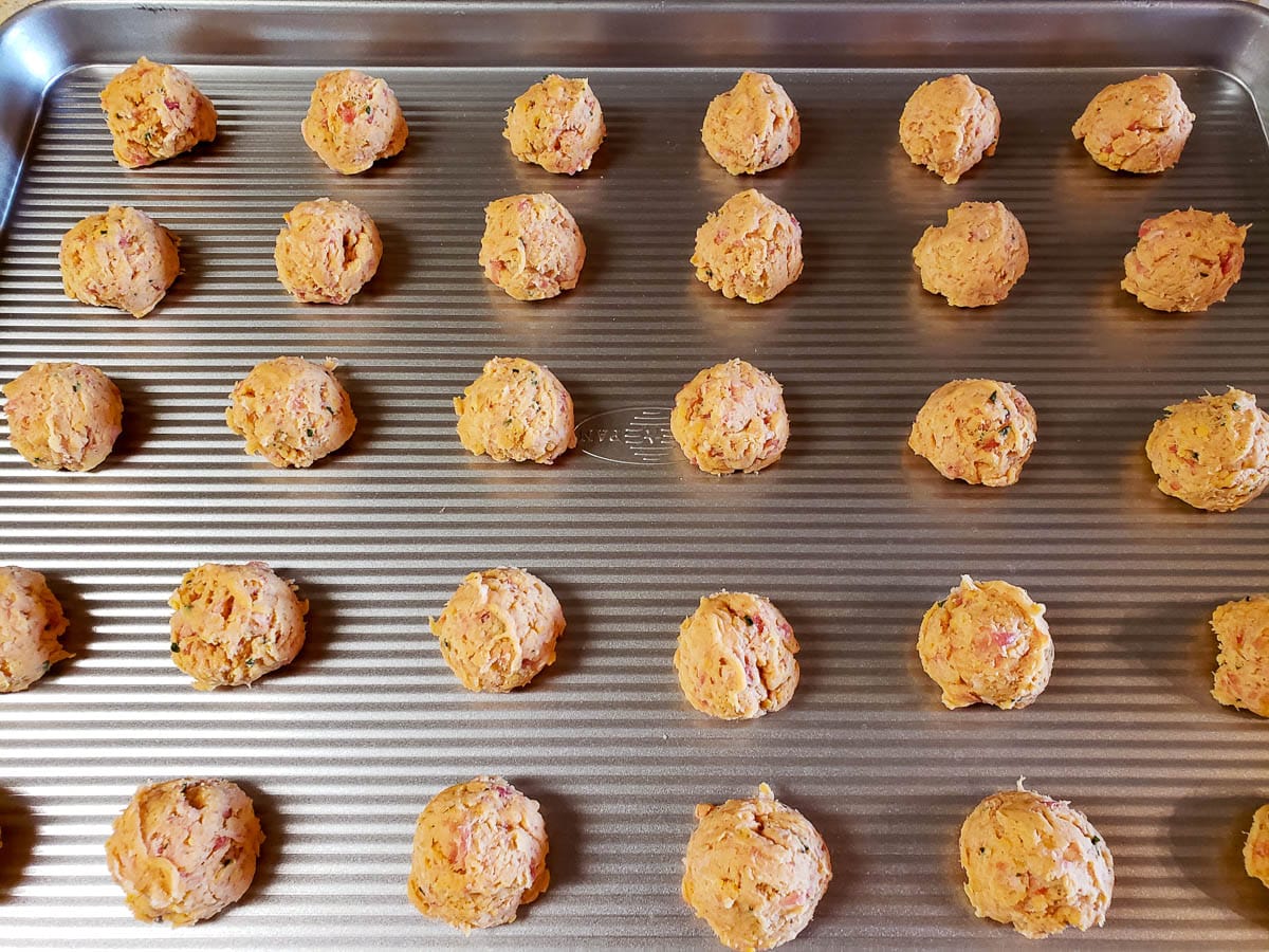 sausage ball dough balls on baking sheet.