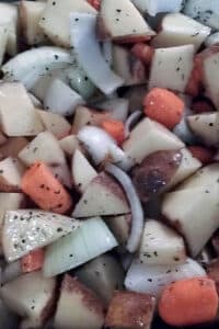chopped potatoes, onions, and carrots drizzled with olive oil and thyme
