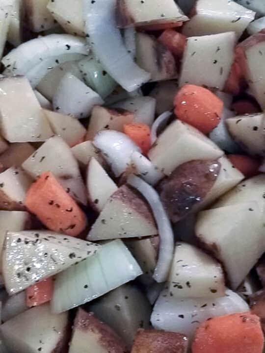 chopped potatoes, onions, and carrots drizzled with olive oil and thyme