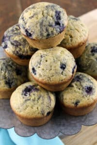 sourodugh blueberry muffins on metal tray with blue napkin
