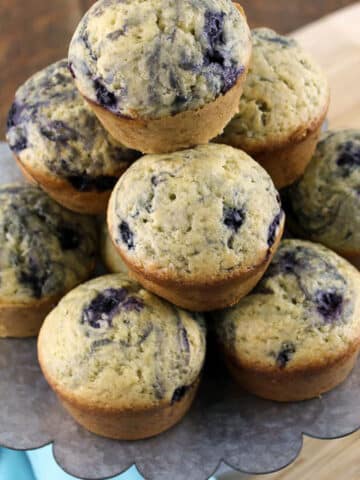 sourodugh blueberry muffins on metal tray with blue napkin