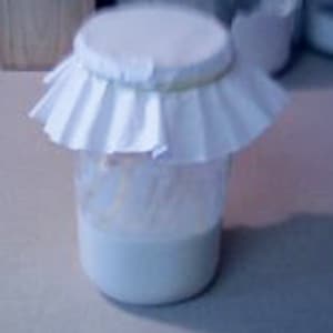 Glass jar covered with coffee filter.