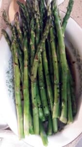Steamed Asparagus with Balsamic Vinaigrette in white bowl.