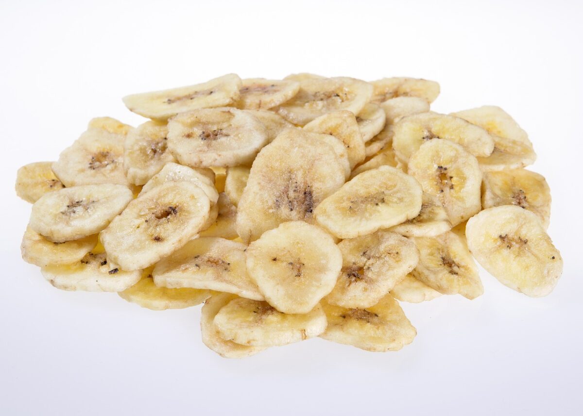 Dehydrated banana chips  on white table.