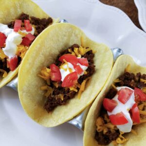 3 tacos on white plate.