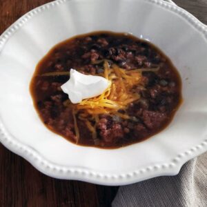 Taco soup in white bowl.