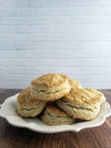 Buttermilk Biscuits on white plate on wooden table.
