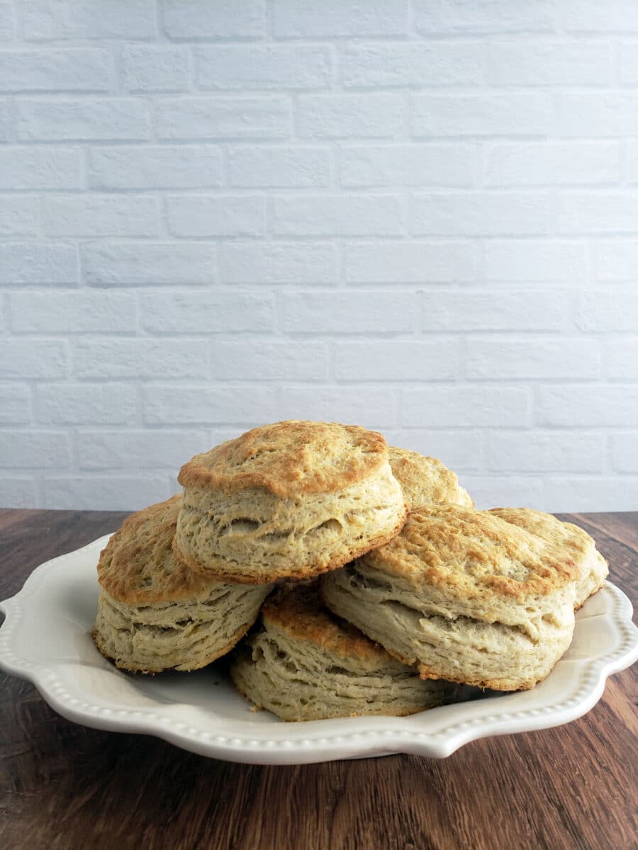 Buttermilk Biscuits on white plate on wooden table.