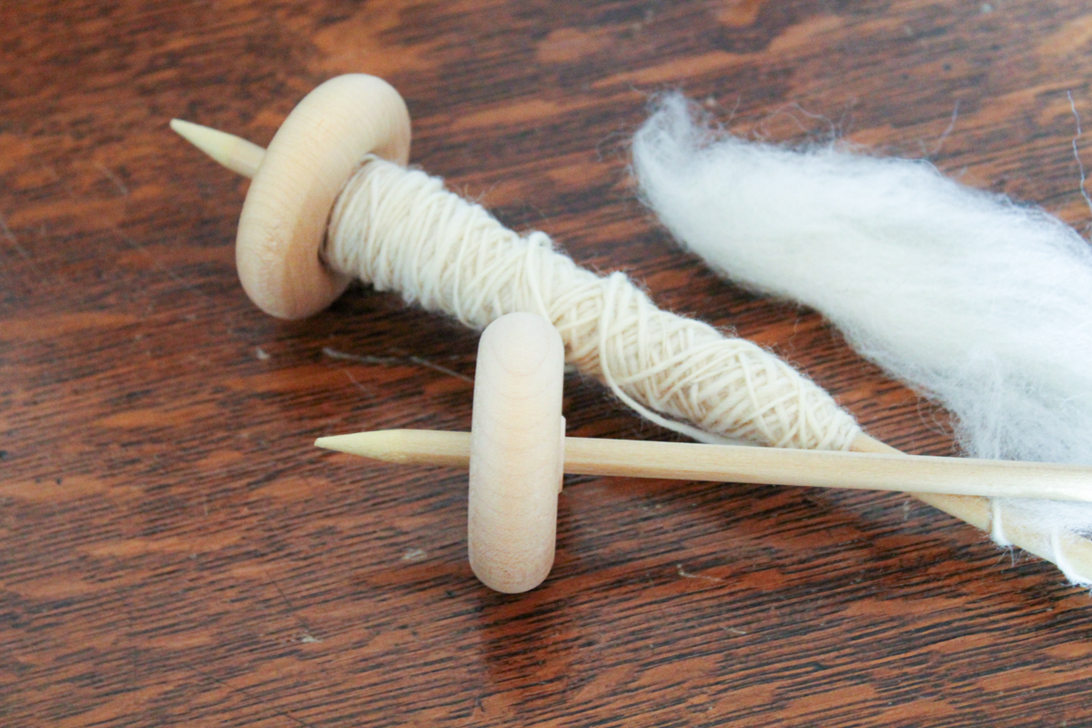 Drop spindles with roving attached.