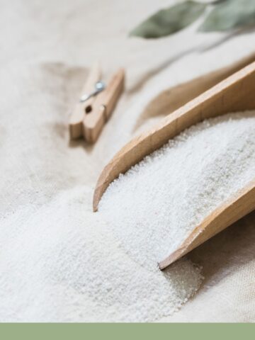 Homemade laundry powder with wooden scoop and clothes pins.