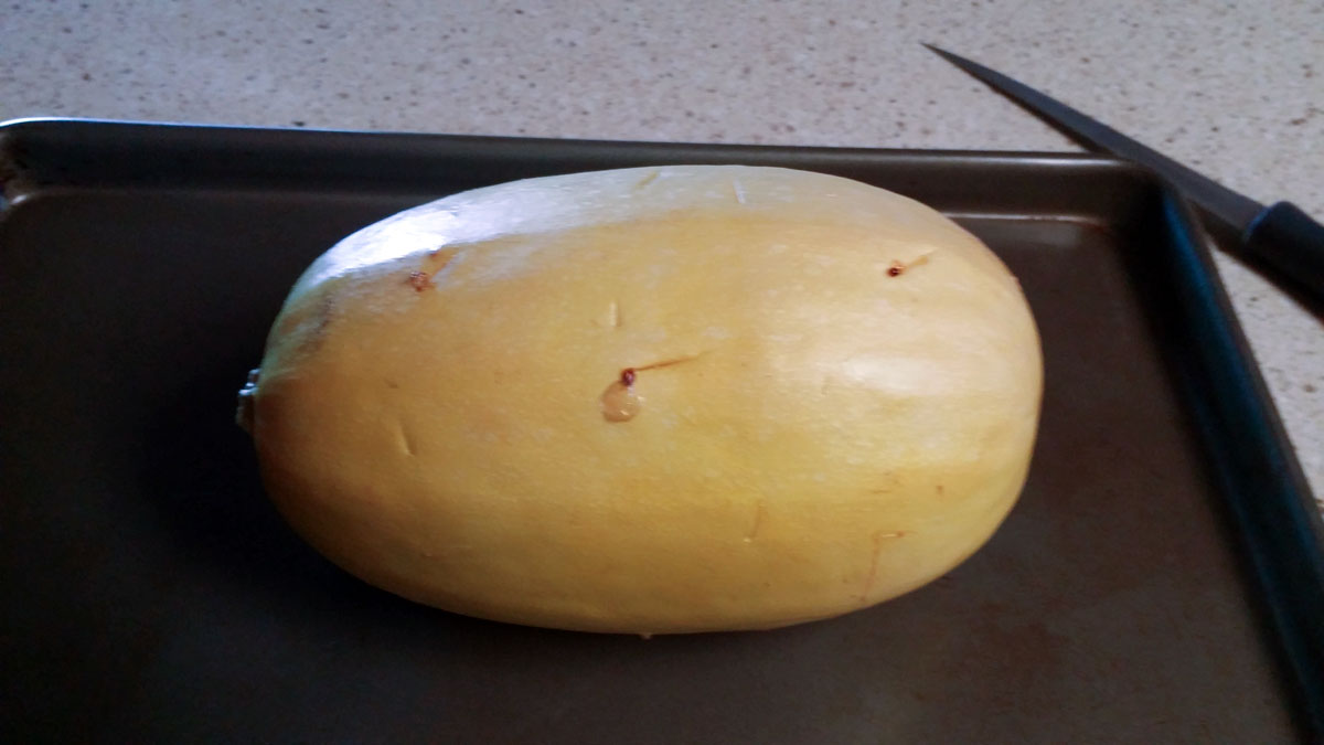 Baked whole spaghetti squash on baling sheet.